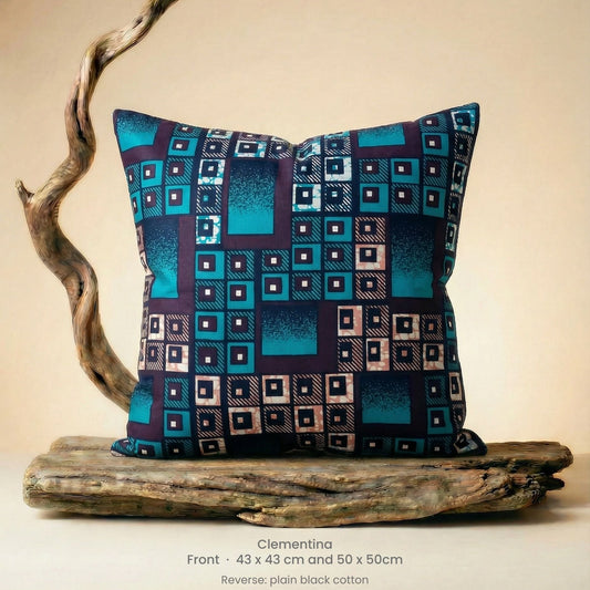 Decorative pillow with geometric pattern on driftwood against a neutral background