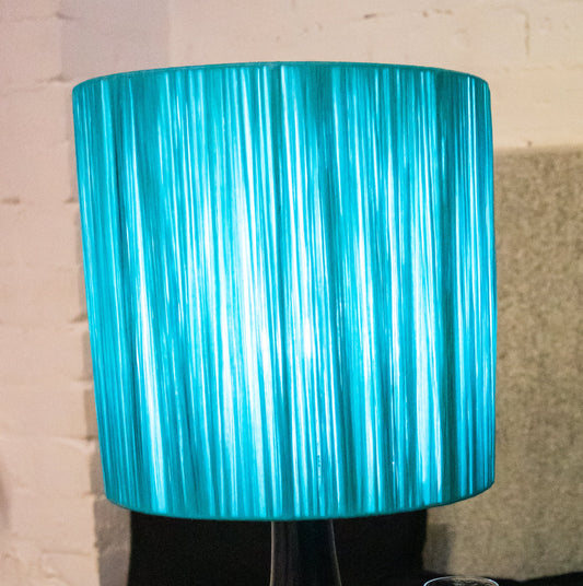 Close up of a turquoise raffia wrapped lampshade.