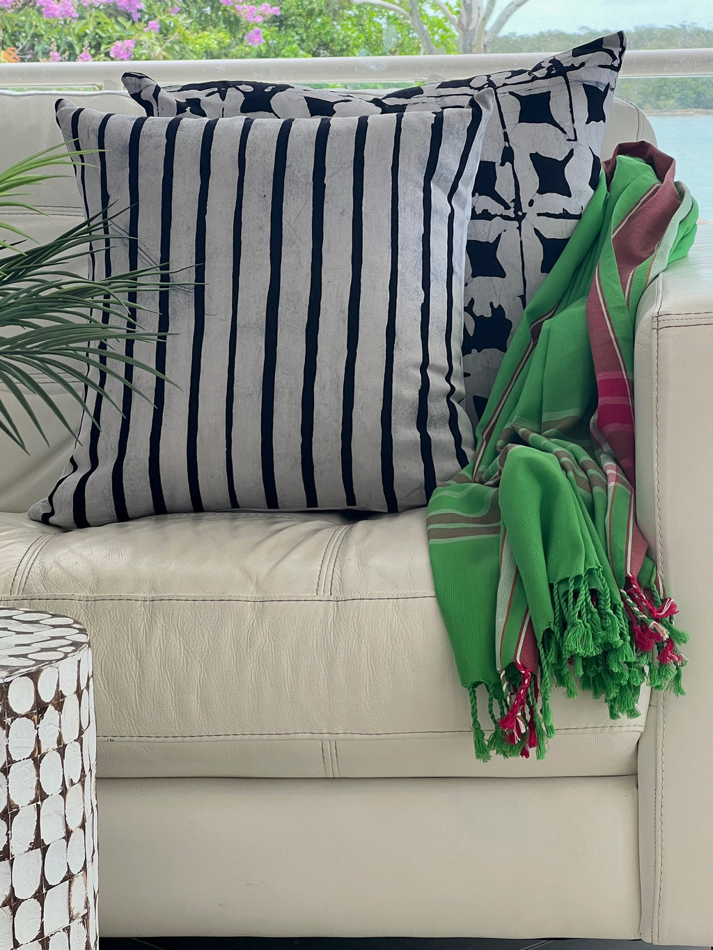 Black & White Cushion Covers with Green Pink & White Throw Rug