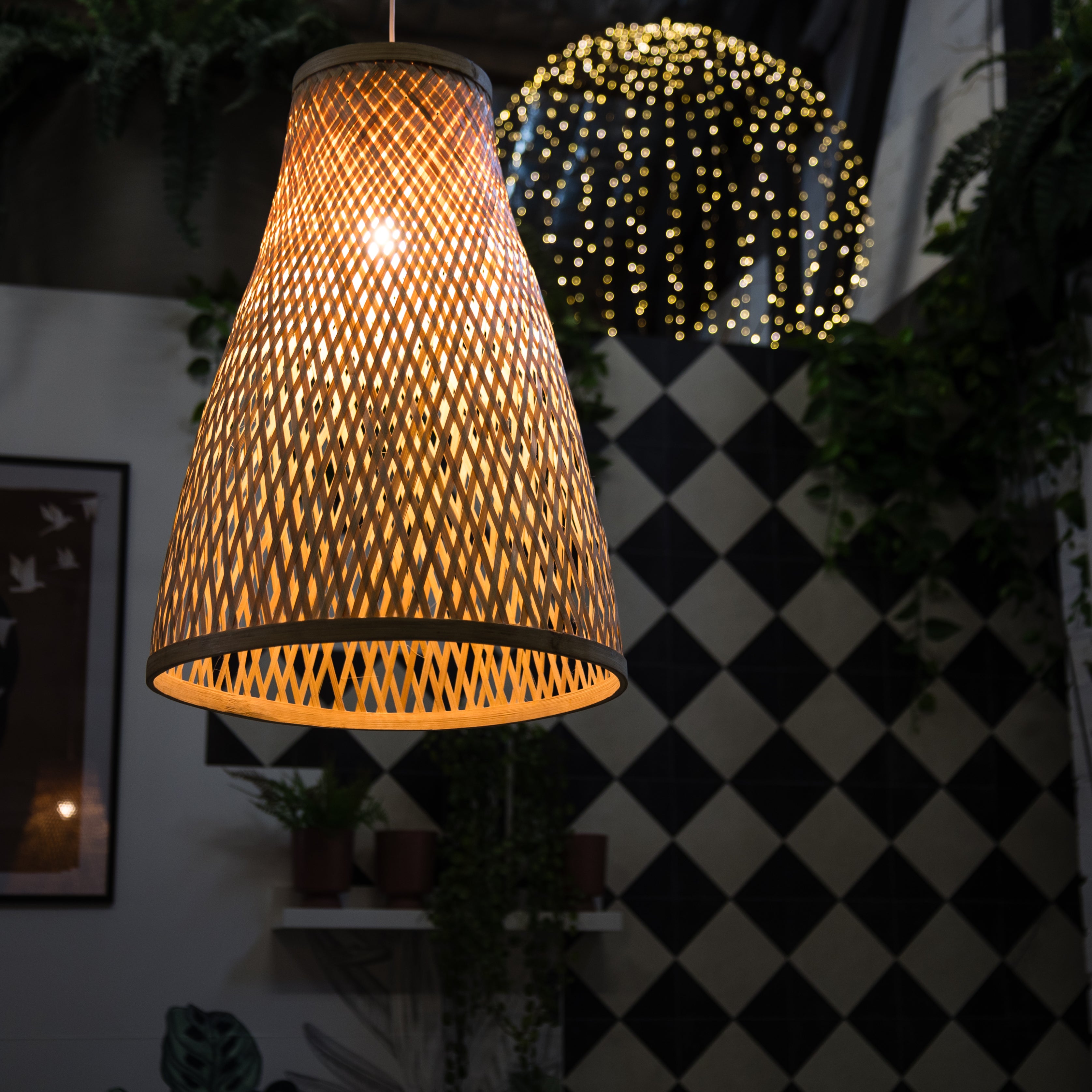 Woven pendant light with a checkered wall and decorative lights in the background