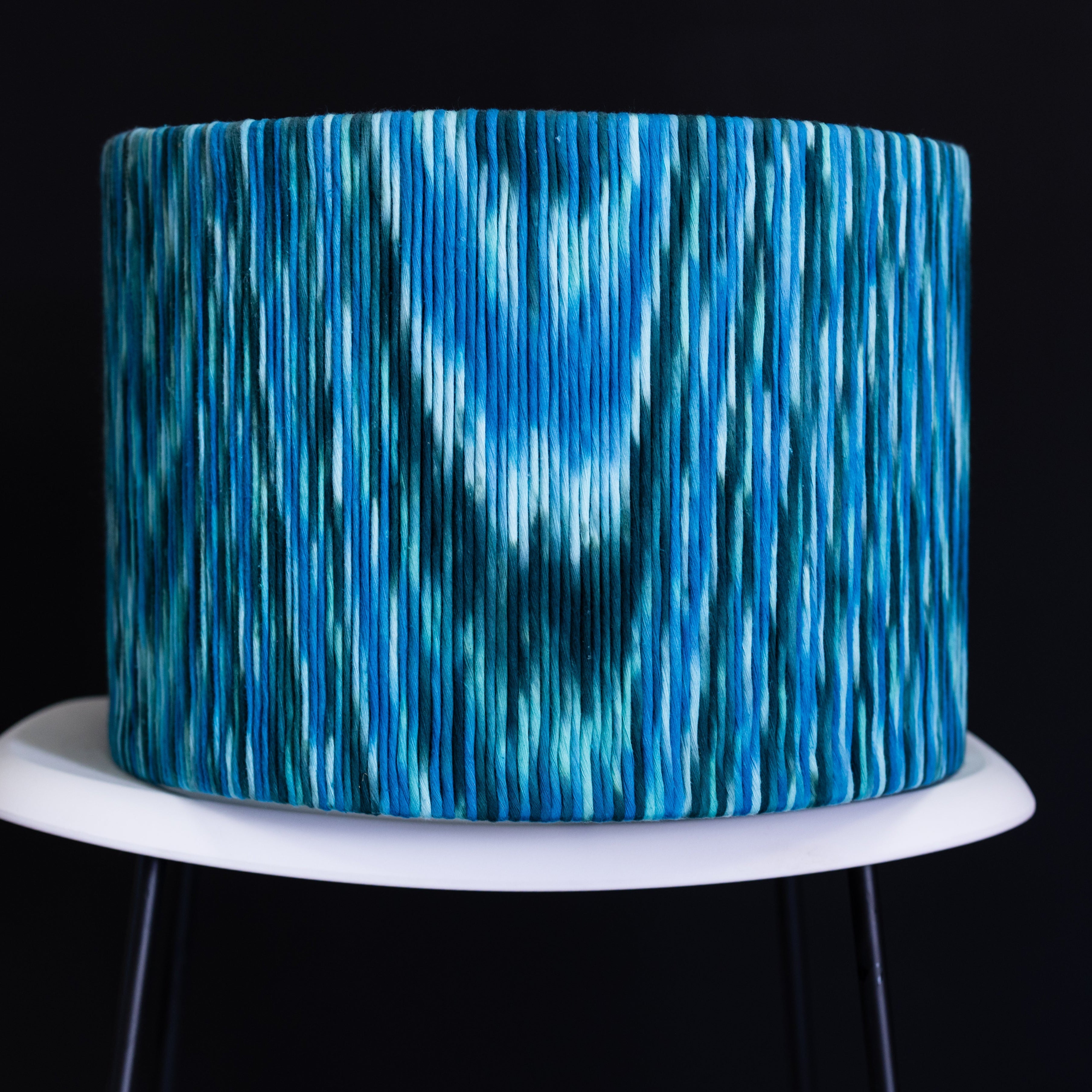 Blue textured lampshade on a black background
