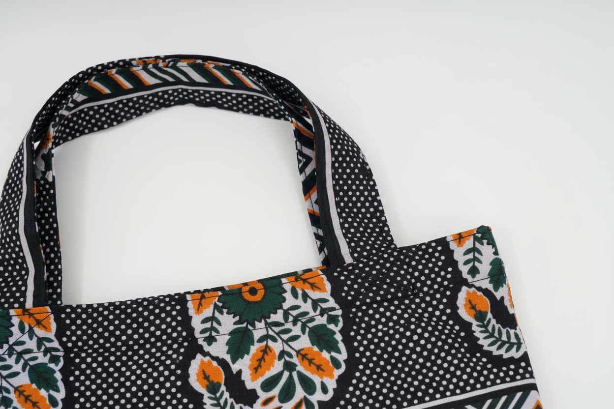 Close-up of handle construction and stitching detail on Chevron Orchard tote showing quality craftsmanship