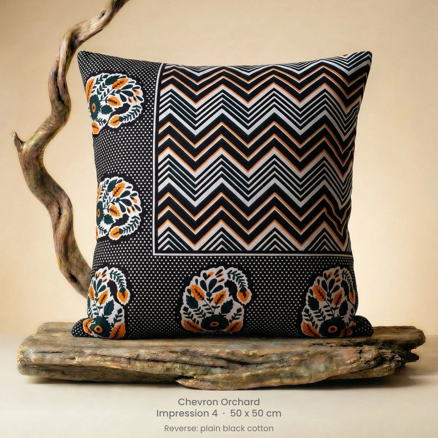 Decorative cushion in orange, black and white on driftwood.