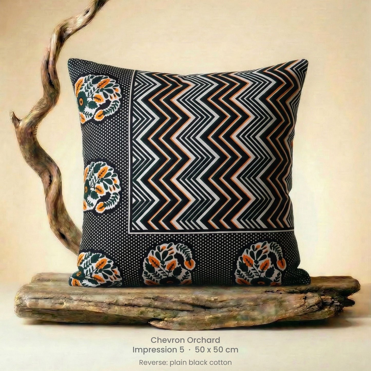 Decorative cushion in orange, black and white on driftwood.