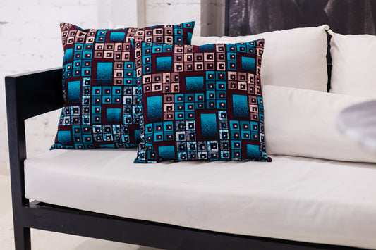Patterned cushions on a white sofa with a white wall background