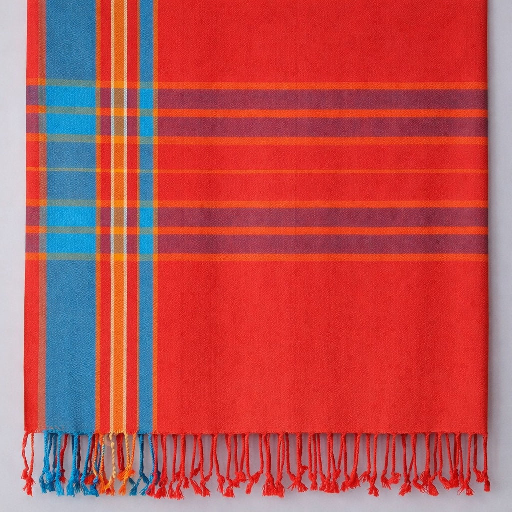 Plaid towel with red, blue, and orange colors on a white background