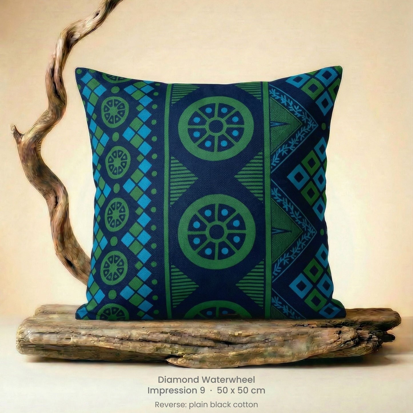 Decorative green, blue and black cushion with geometric pattern on driftwood with a neutral background.