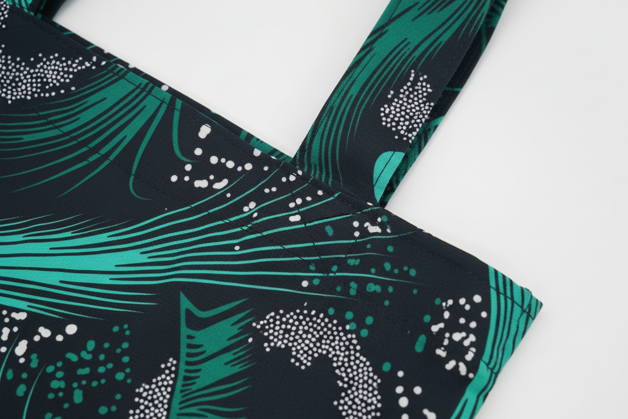 Close-up of handle construction and stitching detail on Emerald Swell tote showing quality craftsmanship