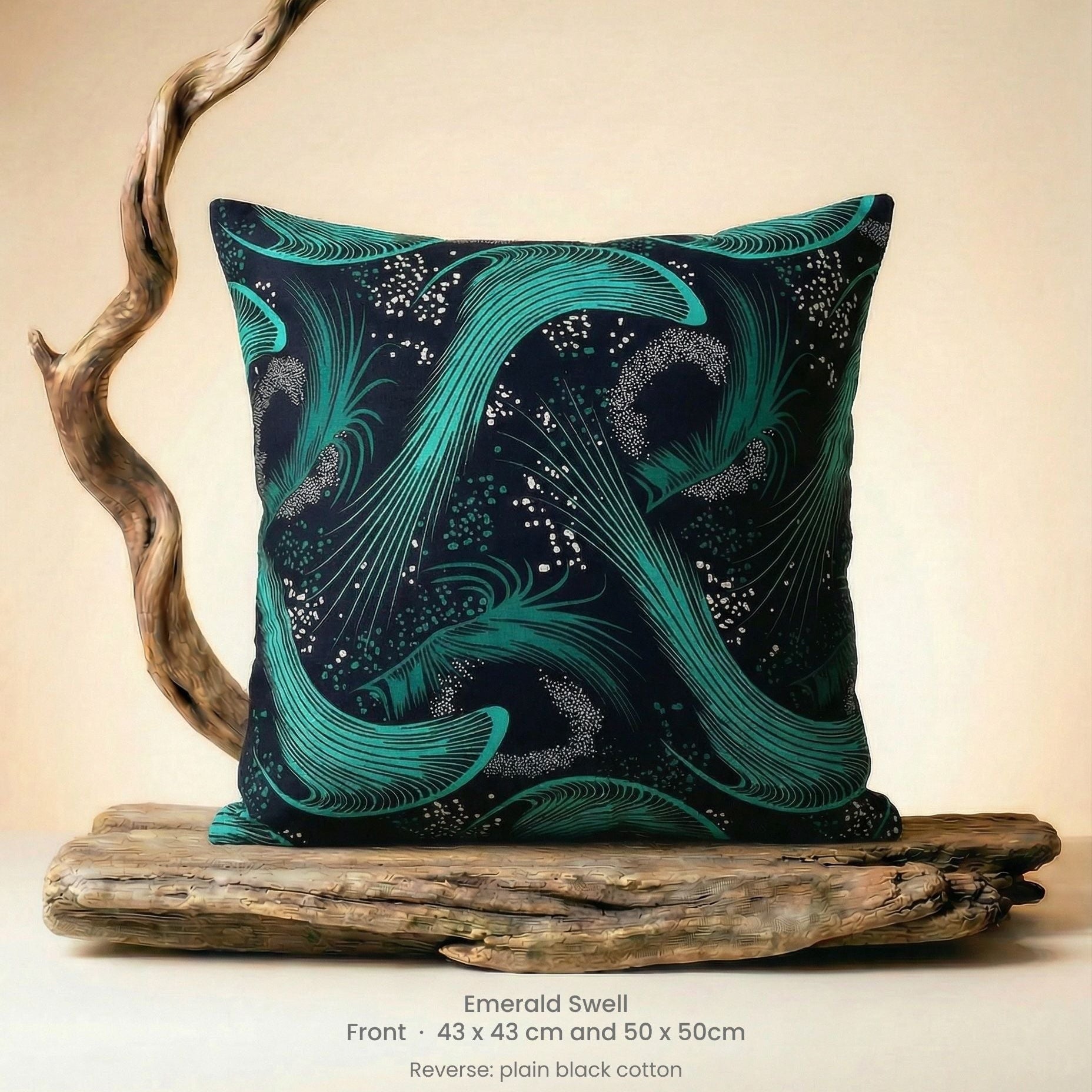 Decorative cushion with green and black abstract design on driftwood with neutral background