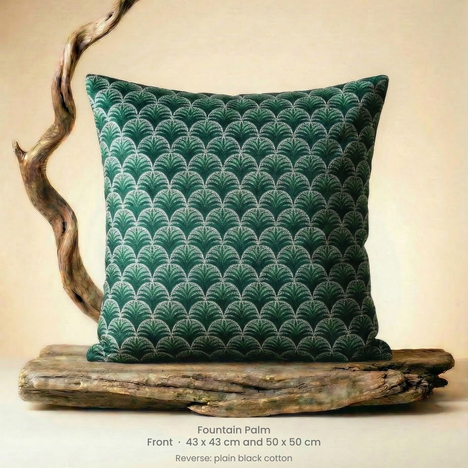 Decorative cushion in green, black and white on driftwood.