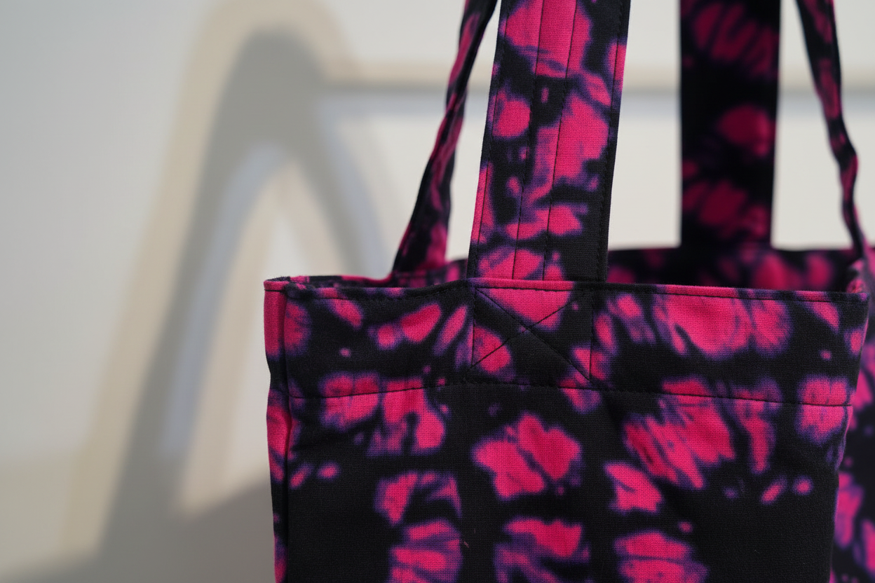 Close-up of handle construction and stitching detail on Ink and Orchid tote showing quality craftsmanship