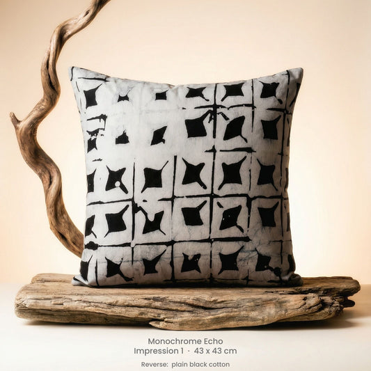 Decorative cushion with black and white pattern on driftwood with a neutral background