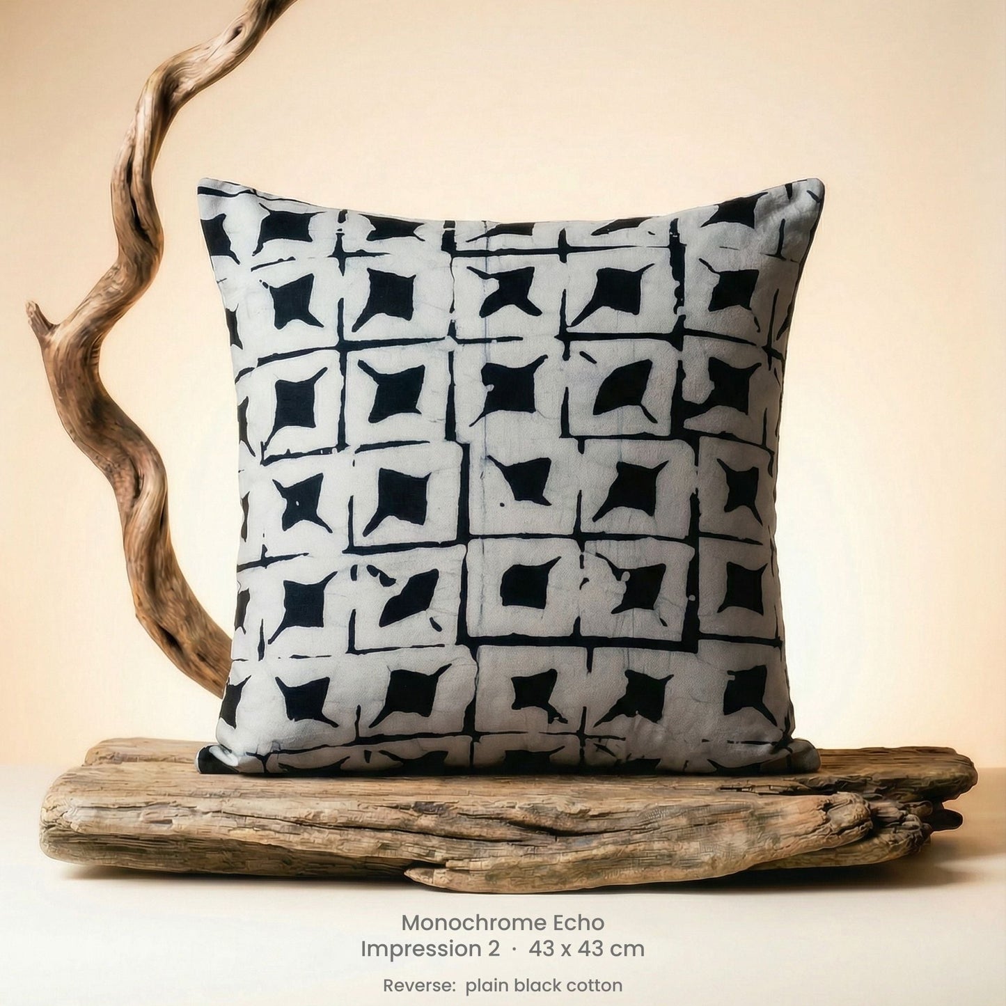 Decorative cushion with black and white pattern on driftwood with a neutral background