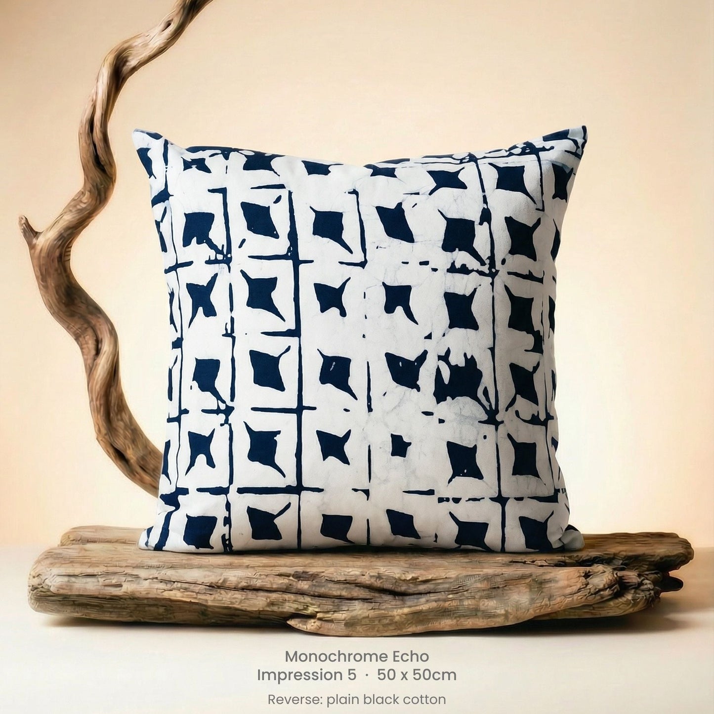 Decorative cushion with black and white pattern on driftwood with a neutral background