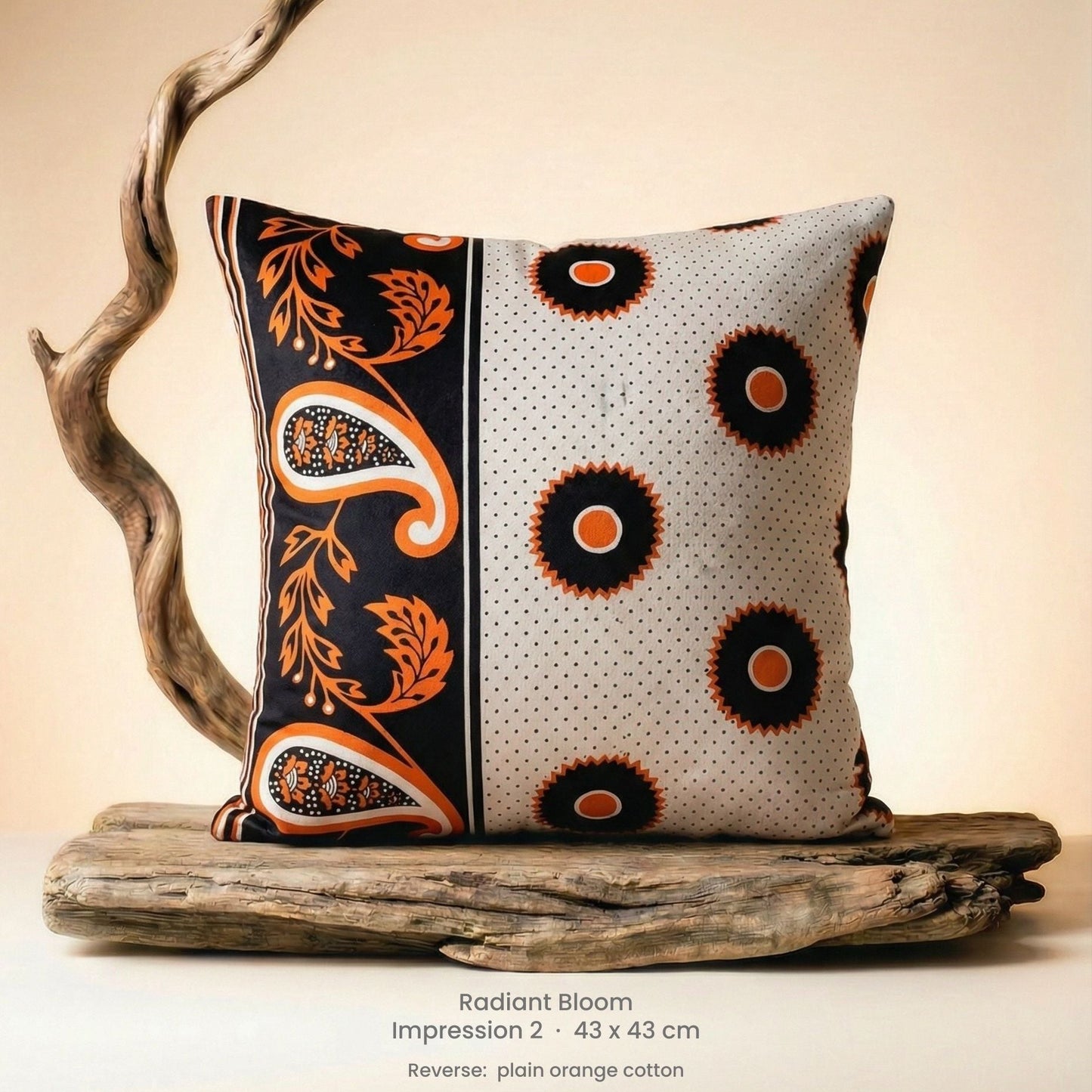 Decorative cushion with orange, black and white pattern on driftwood with a neutral background.