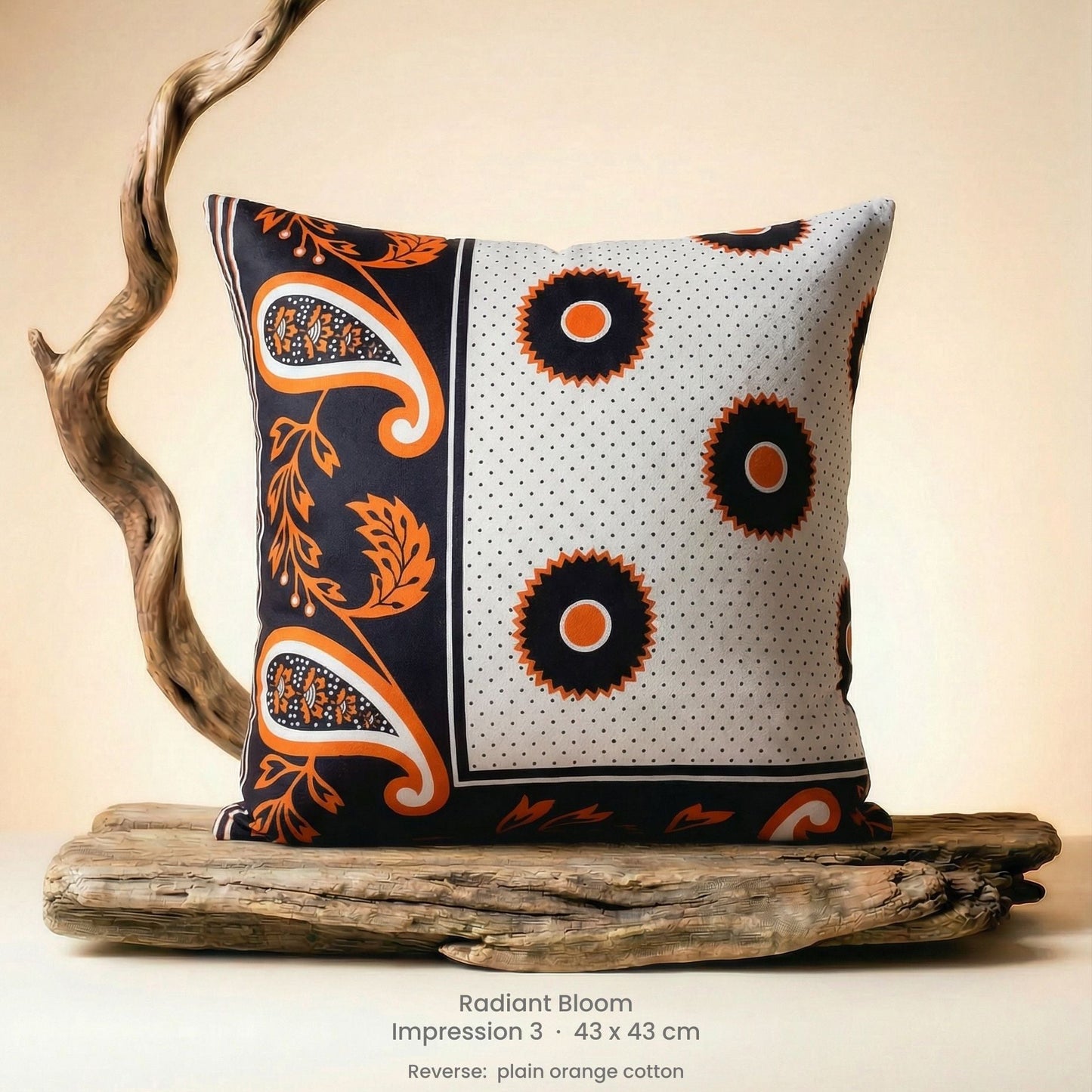 Decorative cushion with orange, black and white pattern on driftwood with a neutral background.