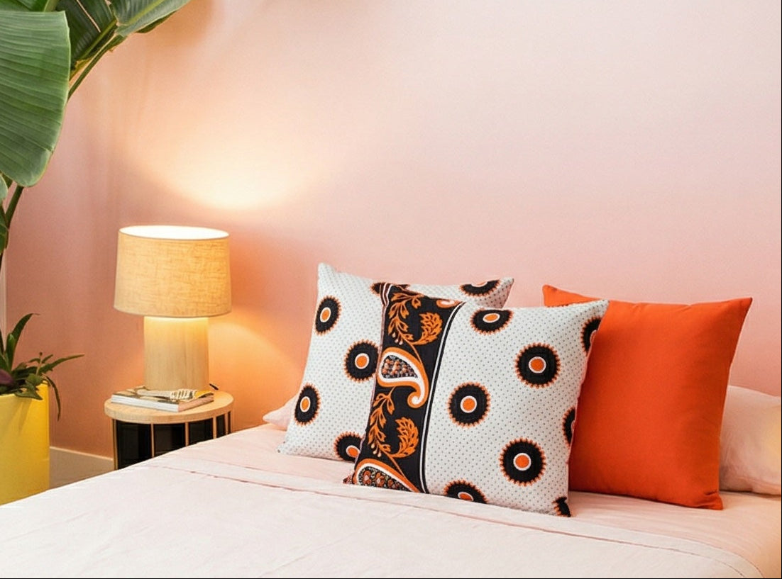 Modern bedroom with a bed, decorative pillows, and plants.