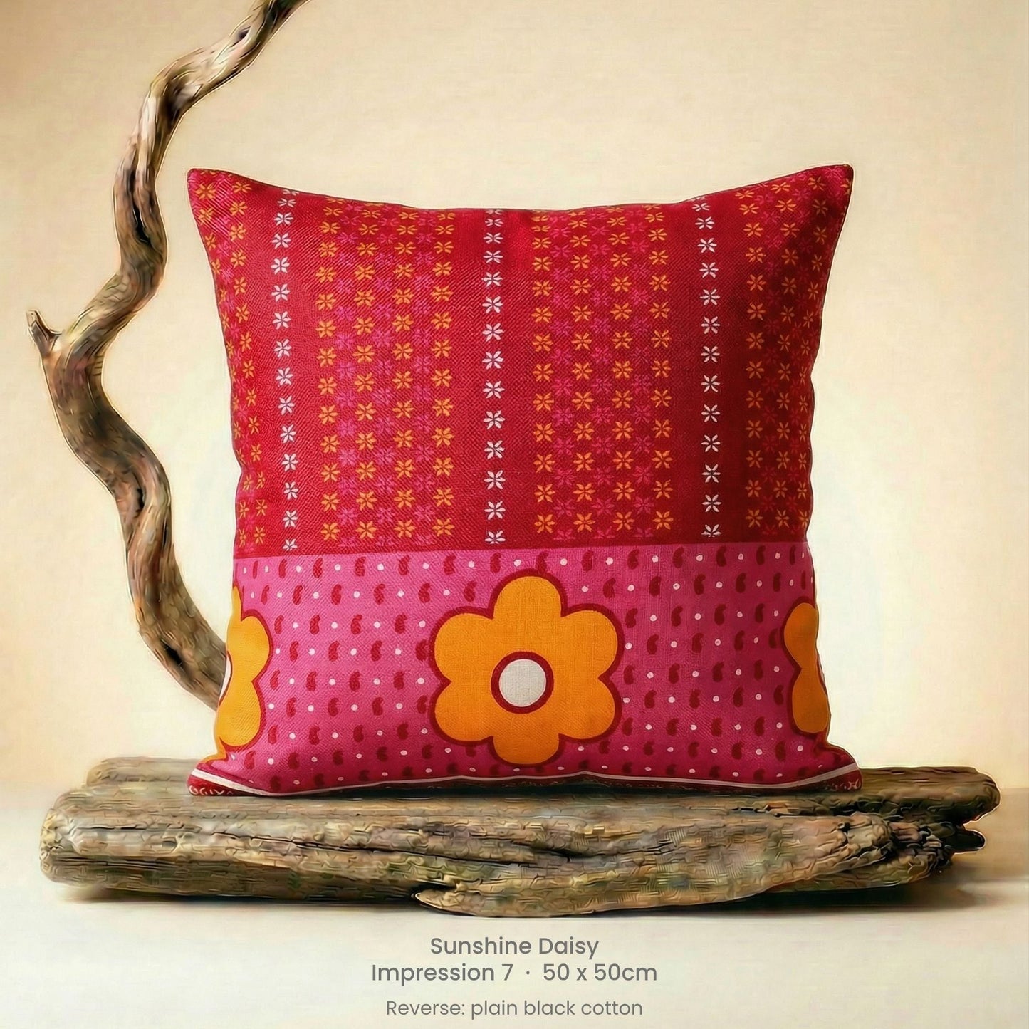 Decorative cushion with floral design in pink, red and yellow on driftwood.